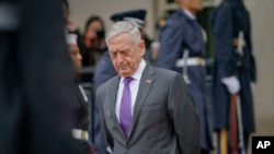 FILE - Defense Secretary Jim Mattis waits for Chinese Minister of Defense General Wei Fenghe to begin an arrival ceremony at the Pentagon, Nov. 9, 2018. 