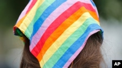 Democratic nominee for the House of Delegates 13th district seat, Danica Roem, wears a rainbow scarf as she greets voters while canvasses a neighborhood, June 21, 2017, in Manassas, Va. 