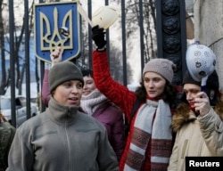 Activists protest in front of Ukraine's Defense Ministry, campaigning for women to be granted more active management and combat roles in the Ukrainian military's conflict with pro-Russian separatists in east Ukraine, in Kiev, Jan. 21, 2016.