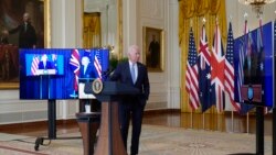 President Joe Biden, joined virtually by Australian Prime Minister Scott Morrison, left, listen as British Prime Minister Boris Johnson, speaks about a national security initiative from the White House in Washington, Sept. 15, 2021.