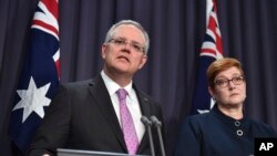 Australian Prime Minister Scott Morrison, left, speaks to the media alongside Foreign Minister Marise Payne during a press conference at the Parliament House in Canberra, Oct. 16, 2018.