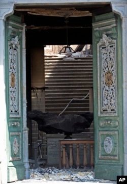 A meteorite on exhibit at the National Museum is seen through a door after a fire in Rio de Janeiro, Brazil, Sept. 3, 2018.