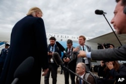 President Donald Trump listens to a question about the missing Saudi journalist Jamal Khashoggi after landing at Cincinnati Municipal Lunken Airport, Oct. 12, 2018, in Cincinnati, Ohio