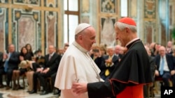 FILE -Pope Francis (L) talks with Papal Foundation Chairman Cardinal Donald Wuerl, Archbishop of Washington, D.C., during a meeting with members of the Papal Foundation at the Vatican, April 17, 2015. 