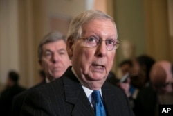 Senate Majority Leader Mitch McConnell, R-Ky., joined at left by Sen. Roy Blunt, R-Mo., speaks after a strategy session, at the Capitol in Washington, Dec. 11, 2018.