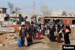 Civilians flee fighting between Iraqi forces and Islamic State fighters north of Mosul, Iraq, Dec. 30, 2016.