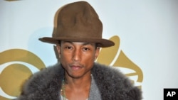 Pharrell Williams arrives at "The Night That Changed America: a Grammy Salute to the Beatles," Jan. 27, 2014, in Los Angeles