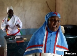 A woman sings during an Easter Sunday service in a church in Garissa, Kenya, April 5, 2015.