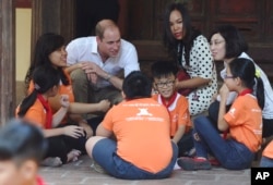 Britain's Prince William, Duke of Cambridge, talks with pupils as he visits a local primary school in downtown Hanoi, Vietnam, Nov. 16, 2016.