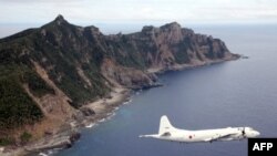 (File) This photo from Oct. 13, 2011, shows Japanese Maritime Self-Defense Force plane flying over the disputed islets known as the Senkaku islands in Japan and Diaoyu islands in China, in the East China Sea.