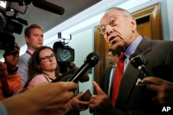 Sen. Chuck Grassley, R-Iowa, right, answers questions from reporters about allegations of sexual misconduct against Supreme Court nominee Brett Kavanaugh as he arrives for a Senate Finance Committee hearing on Capitol Hill in Washington, Sept. 26, 2018.