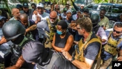 Martine Moise, center, the widow of slain President Jovenel Moise, arrives at the courthouse to give testimony in the investigation into the assassination of her husband, in Port-au-Prince, Haiti, Oct. 6, 2021.