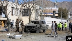 Afghan security forces inspect the site of a suicide attack in Kabul, Afghanistan, Nov. 16, 2014. 