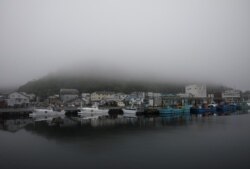 A heavy shroud of morning mist fills a port in Rausu, Hokkaido, Japan, July 2, 2019.