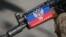 A pro-Russian armed man guards a barricade in Slaviansk, Ukraine. The sticker on his rifle reads "Republic of Donetsk." April 28, 2014.