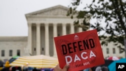 People rally outside the Supreme Court as oral arguments are heard in the case of President Trump's decision to end the Obama-era, Deferred Action for Childhood Arrivals program (DACA), Nov. 12, 2019, at the Supreme Court in Washington. 