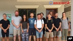 In this file photo dated Jan. 27, 2018, issued by Cambodian National Police, a group of foreigners stand after they were arrested for "dancing pornographically" at a party in Siem Reap town, near the country's famed Angkor Wat temple complex. 