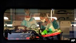 Medical staff take care of patients infected with the COVID-19 virus in a train at the Gare d'Austerlitz train station April 1, 2020 in Paris, France.