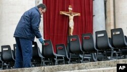 Workers install chairs in St. Peter's Square at the Vatican, March 18, 2013 for Pope Francis' Installation Mass on Tuesday. 