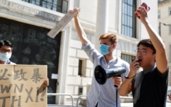 A former British Consulate employee, Simon Cheng, speaks during a protest against Hong Kong's deteriorating freedoms outside China's embassy, in London, July 31, 2020.