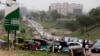 Cars queue to buy fuel at a petrol station in Abuja, Nigeria, Friday, April 1, 2016. 