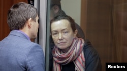 FILE - Russian-American journalist for Radio Free Europe/Radio Liberty Alsu Kurmasheva, who is in custody after she was accused of violating Russia's law on foreign agents, listens to a lawyer at a court hearing in Kazan, Russia, Dec. 1, 2023.