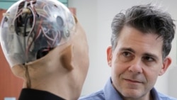 FILE - In this Sept. 28, 2017, photo, David Hanson, the founder of Hanson Robotics, talks with his company's flagship robot Sophia, a lifelike robot powered by artificial intelligence in Hong Kong.