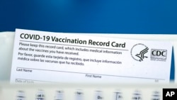 A vaccination record card is shown during a COVID-19 vaccination drive for Spring Branch Independent School District education workers, March 16, 2021, in Houston, Texas.