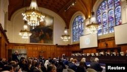 FILE - Delegates attend the U.N.'s International Court of Justice public hearings in an advisory opinion case that may become a reference point in defining countries' legal obligations to fight climate change, in The Hague, Netherlands, Dec. 2 2024. 