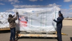 FILE - Zimbabwe officials inspect one million SINOVAC vaccines it bought from China on July 25, 2021 in Harare. (VOA/Columbus Mavhunga)