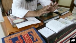 FILE - Judge Mufti Abdul Qayyum listens during the hearing of a divorce case at a Darul Qaza or Islamic Court in Ahmadabad, India.