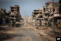 FILE - In this Oct. 22, 2011 file photo, a general view of buildings ravaged by fighting in Sirte, Libya.