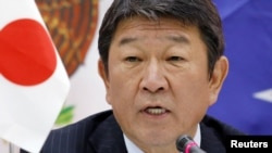 Japan's Economy Minister Toshimitsu Motegi says, Jan. 23, 2018, eleven countries aiming to forge an Asia-Pacific trade pact after the United States pulled out of an earlier version will sign an agreement in Chile in March.