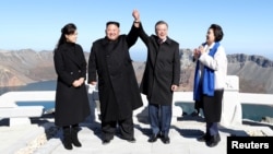 FILE - South Korean President Moon Jae-in and North Korean leader Kim Jong Un pose for photographs on the top of Mt. Paektu, North Korea, Sept. 20, 2018.