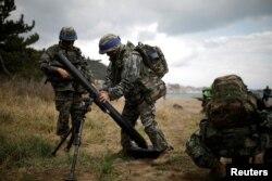 FILE - South Korean marines take part in a U.S.-South Korea joint landing operation drill as a part of the two countries' annual military training called Foal Eagle, in Pohang, South Korea, April 2, 2017.