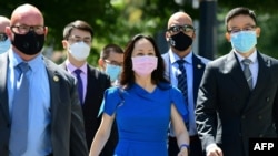 Huawei chief financial officer Meng Wanzhou arrives at British Columbia Supreme Court with her security detail for the afternoon session of her extradition hearing in Vancouver, Canada, on Aug. 4, 2021.
