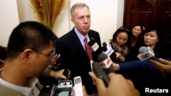 FILE - U.S. Ambassador to Vietnam, Ted Osius (C) speaks to the media at a bilateral conference at the Government Guesthouse in Hanoi.