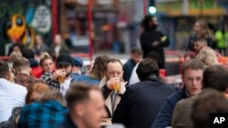 Members of the public are seen at a bar in Manchester's Northern Quarter, England, July 4, 2020.