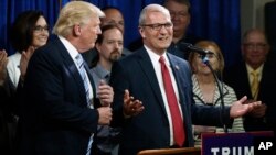 FILE - U.S. Rep. Kevin Cramer, R-N.D., right, talks about being one of the first to endorse then Republican presidential candidate Donald Trump during the North Dakota Republican National Convention in Bismarck, May 26, 2016.