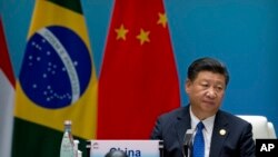 Chinese President Xi Jinping listens to a speech during the Dialogue of Emerging Market and Developing Countries in Xiamen in southeastern China's Fujian Province, Tuesday, Sept. 5, 2017. 