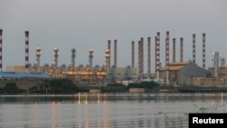 FILE - A general view of Abadan oil refinery in southwest Iran, is pictured from the Iraqi side of Shatt al-Arab in Al-Faw south of Basra, Iraq, Sept. 21, 2019. 