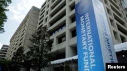 FILE - The International Monetary Fund headquarters building is seen during the IMF/World Bank spring meetings in Washington, April 21, 2017.