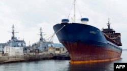 FILE - A Tanzania-flagged vessel, intercepted by the French navy in international waters between Sardinia in Italy and Algeria, is seen moored in the naval base of Toulon, southern France, Oct. 15, 2013.