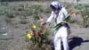 A mourner pays respects at Khavaran cemetery near Tehran. (RFE/RL)