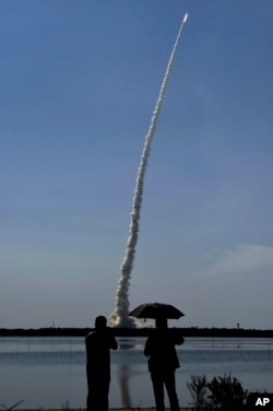 Spectators watch as India’s polar satellite launch vehicle (PSLV C-34) takes off from the Satish Dhawan Space Center in Sriharikota, June 22, 2016. The rocket carries 20 satellites. (R. Senthil Kumar/Press Trust of India via AP)
