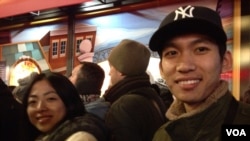 Xiaoguang Zhu, right and Juewei Wang, left from Shanghai, China hope to find deals on leather goods as they wait in line for Macy's Herald Square store to open in New York, on Thanksgiving, Nov. 28, 2013. (Photo Sandra Lemaire)