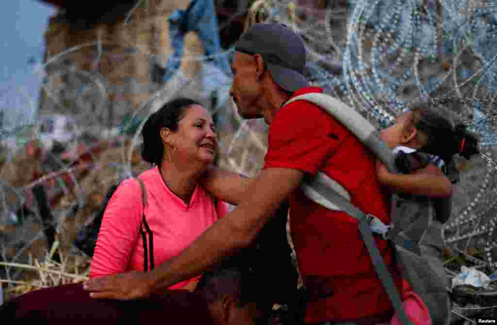Asylum seekers wait on the banks of the Rio Bravo river after crossing during their journey through Mexico to Eagle Pass, Texas, in Piedras Negras, Mexico, Sept. 26, 2023.