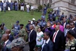 Former South African President Jacob Zuma waves to supporters as he leaves the High Court in Durban, South Africa, April 6, 2018.