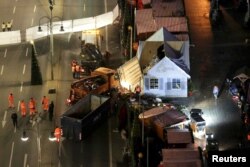 Workers continue to clear the site of a Christmas market in Berlin, Germany, Dec. 21, 2016. A truck plowed through a crowd at the Christmas market on Monday night, killing 12 people.