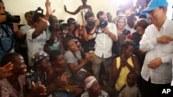 U.N. Secretary-General Ban Ki-moon, right, speaks with women whose homes were destroyed by Hurricane Matthew, in a school where they have sought shelter in Les Cayes, Haiti, Oct. 15, 2016.